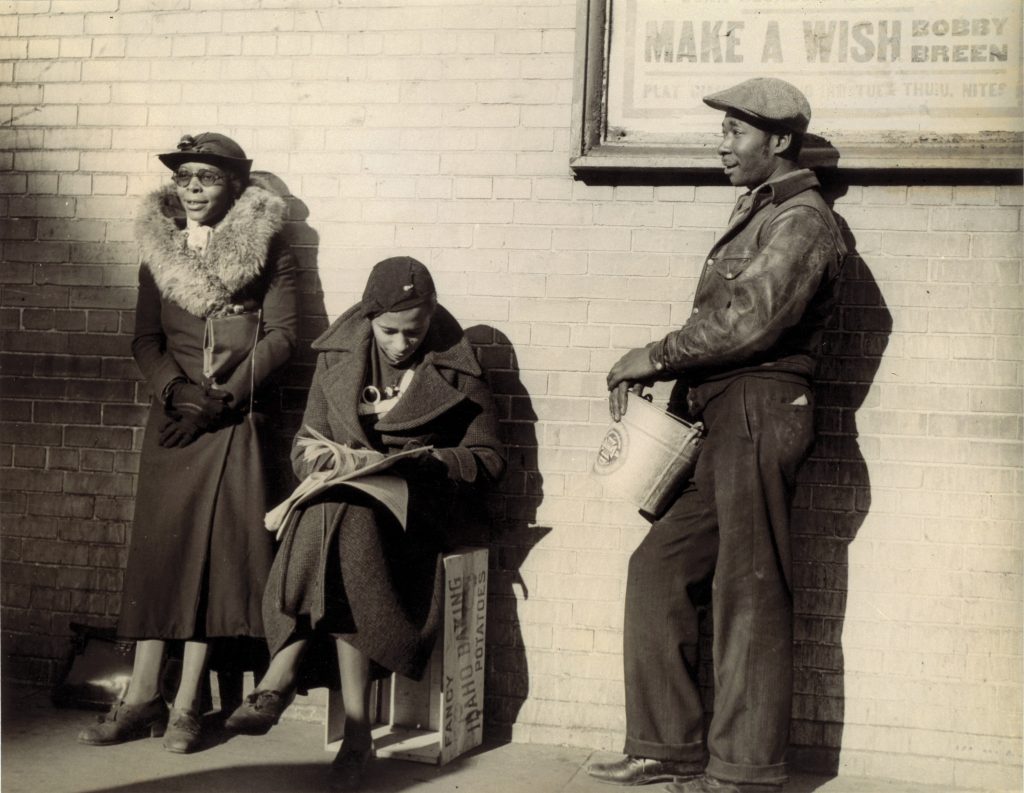 Photo: The women in this photo are domestic workers hoping to be hired for a day’s work, as captured by Robert McNeill for Fortune magazine. Source: U.S. DOL, citing Robert McNeill, Make A Wish (Bronx Slave Market, 170th Street, New York), 1938, Smithsonian American Art Museum.