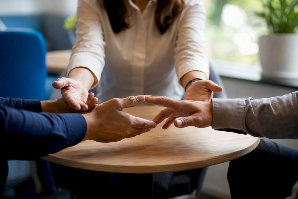 Mediator's hands guiding participants in mediation
