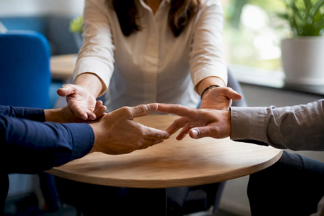 Mediator's hands guiding participants in mediation