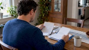 Employee comparing health coverage information at home
